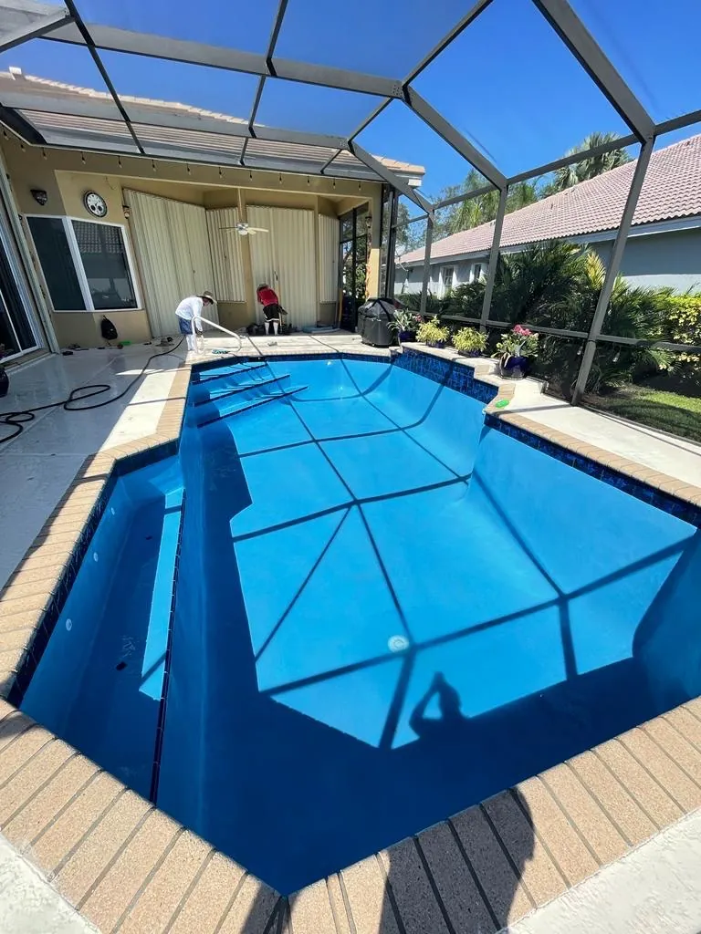 Bright blue interior finish in a pool under a screen enclosure.