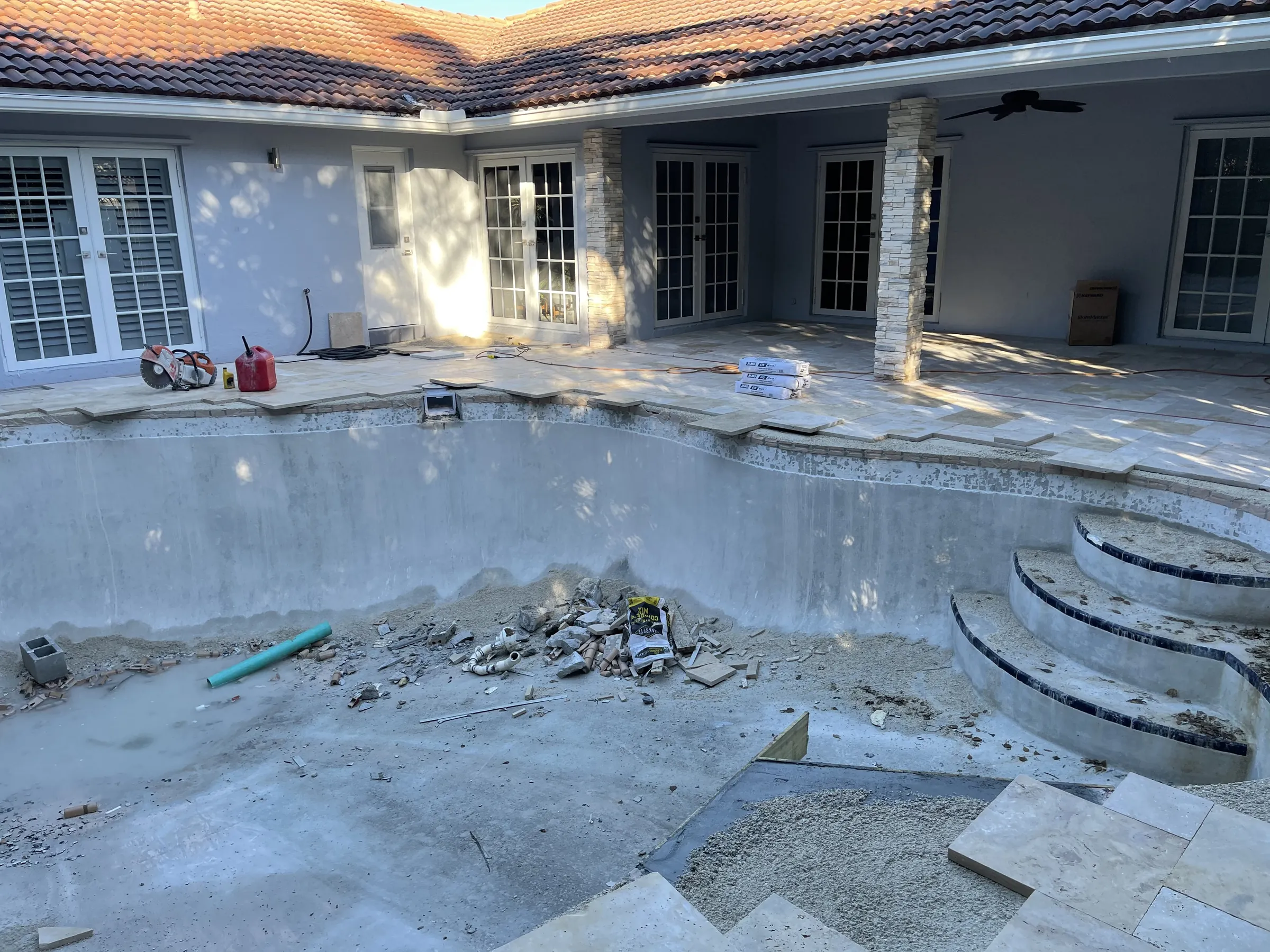 In progress: curved steps and the plaster shell exposed during demolition.